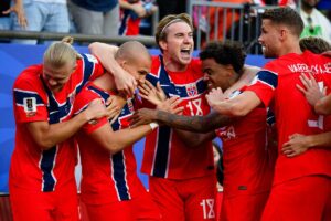 Erling Haaland celebrating with teammates after Norway beat Iraq