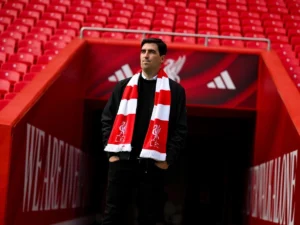 Andoni Iraola wearing a Liverpool scarf at Anfield tunnel