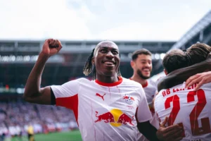 Yan Diomande celebrating an RB Leipzig goal on the pitch