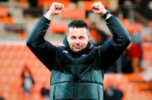 Pierre Sage celebrating a win with Lens at stadium