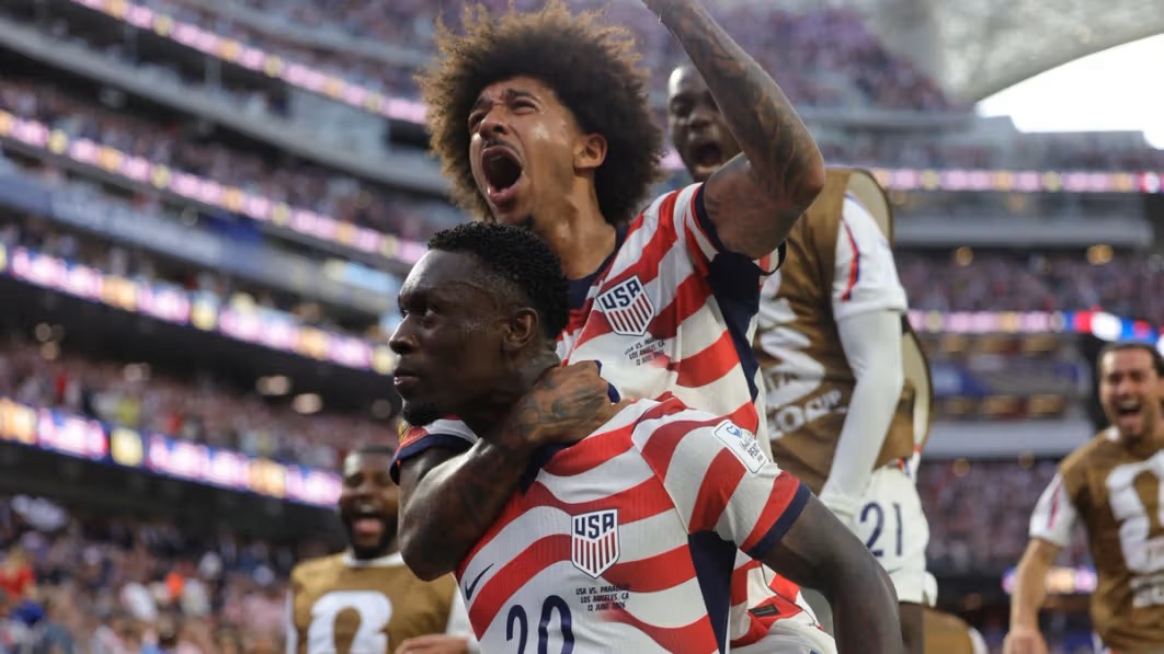 Folarin Balogun celebrating with teammates after scoring for USA against Paraguay at World Cup 2026