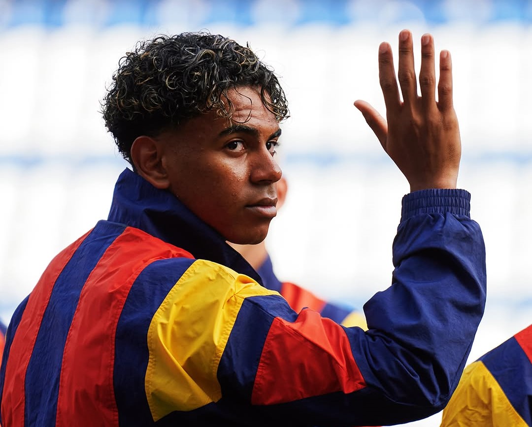Lamine Yamal waving to a crowd in Spain's training camp