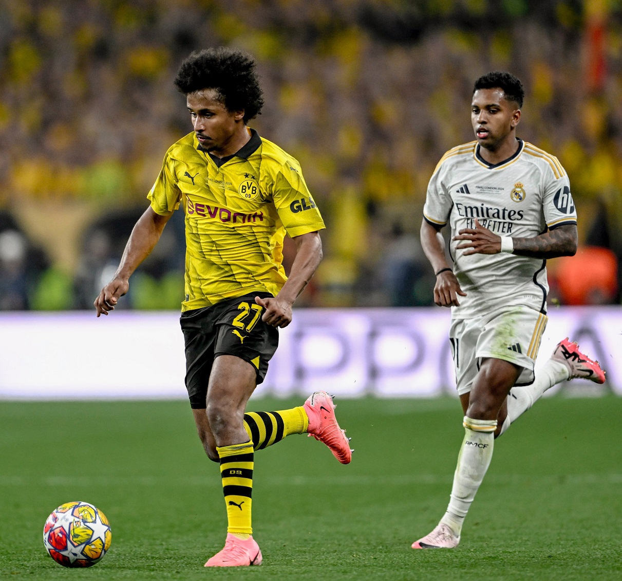 Karim Adeyemi (left) evades Real Madrid's Rodrygo