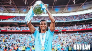 Nathan Ake holding up an FA Cup trophy