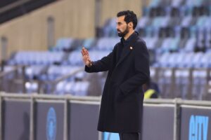 Alvaro Arbeloa standing on the sidelines in a stadium