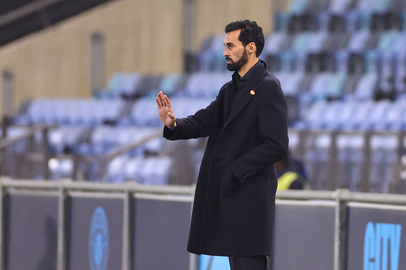 Alvaro Arbeloa standing on the sidelines in a stadium