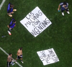 Argentina players standing around a banner on the pitch