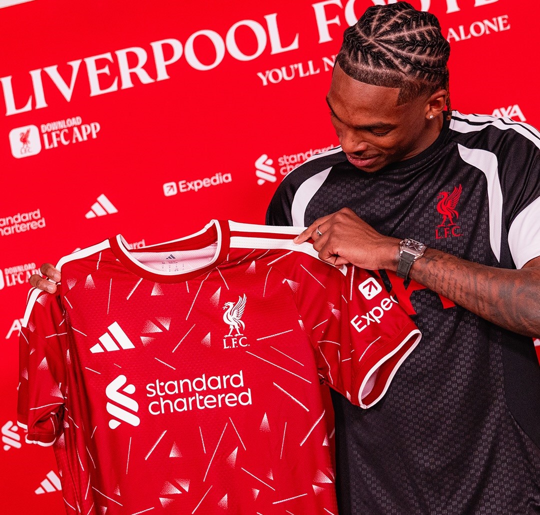 Jeremy Jacquet holding up Liverpool jersey