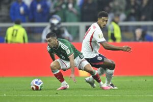 Mexico's Erik Lira gets past England's Jude Bellingham during their World Cup last-16 tie.