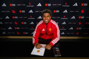 Andrey Santos posing after signing a contract at Manchester United