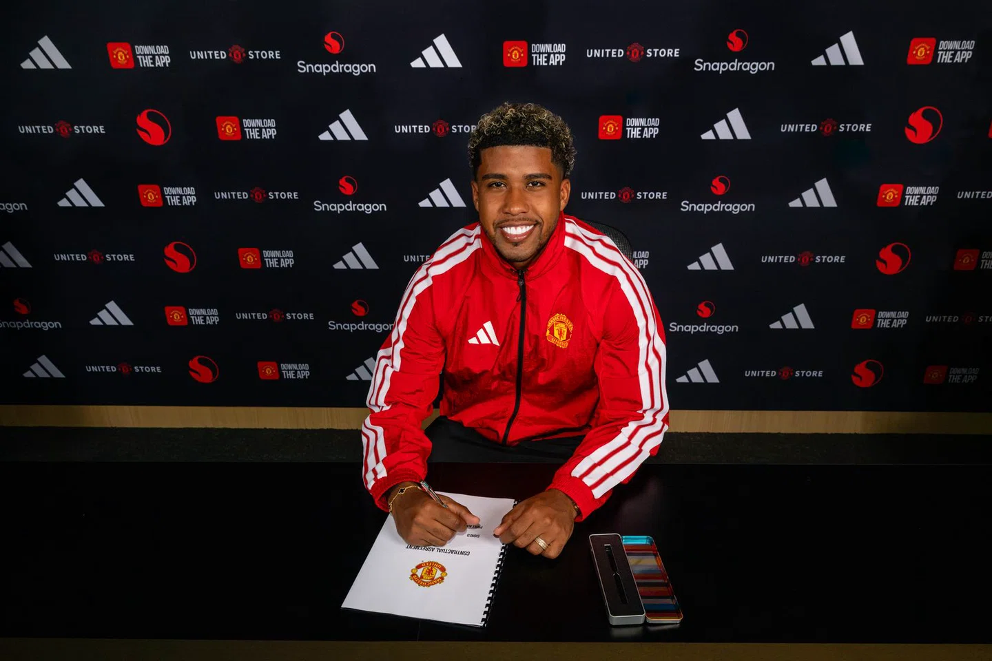Andrey Santos posing after signing a contract at Manchester United