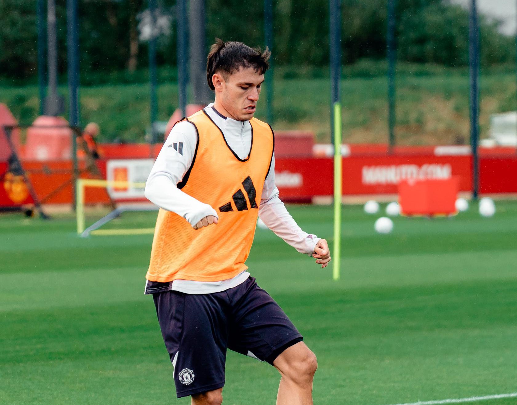 Manuel Ugarte running with the ball during training with Manchester United