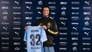 Ayyoub Bouaddi posing with a Manchester City jersey