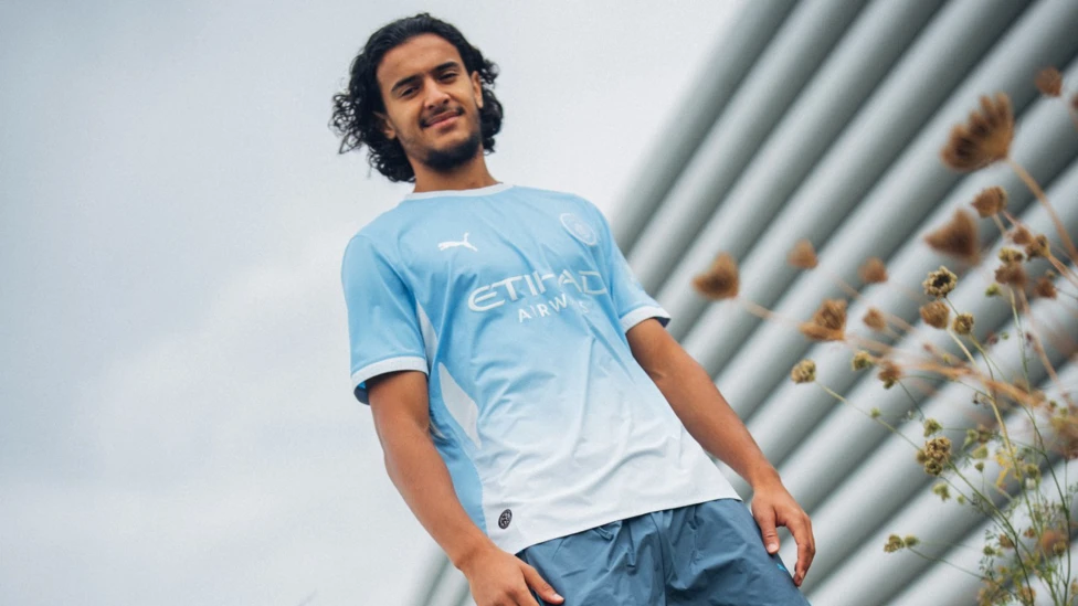 Ayyoub Bouaddi posing in a Manchester City shirt