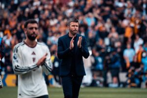 Michael Carrick and Bruno Fernandes applauding Manchester United away fans