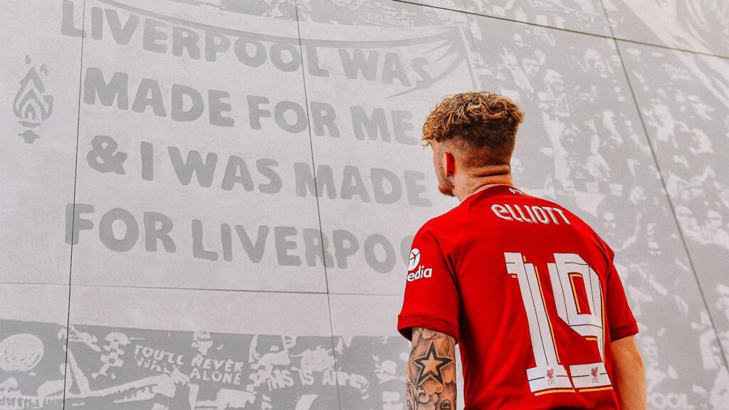 Harvey Elliot staring at a Liverpool graphic