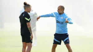 Kalvin Phillips listening to Pep Guardiola give instructions