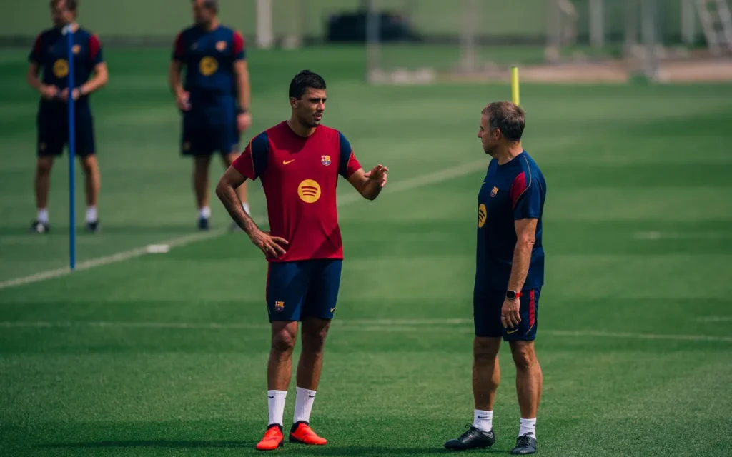 Hansi Flick and Rodri chatting during a training session