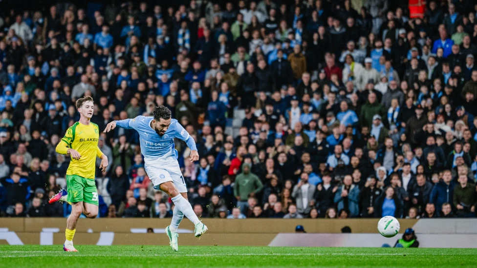 Rayan Cherki scoring a goal for Manchester City against Norwich