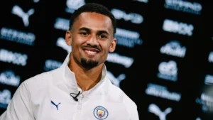 Illman Ndiaye posing in a Manchester City shirt