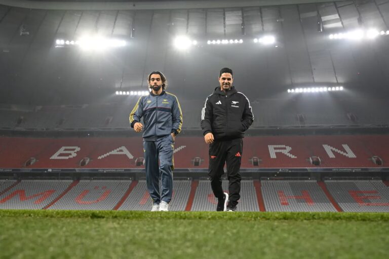 David Raya and Mikel Arteta walking on the pitch