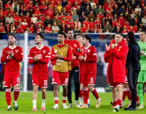 Wales players applauding fans after defeat by Denmark