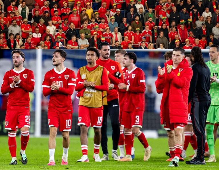 Wales players applauding fans after defeat by Denmark