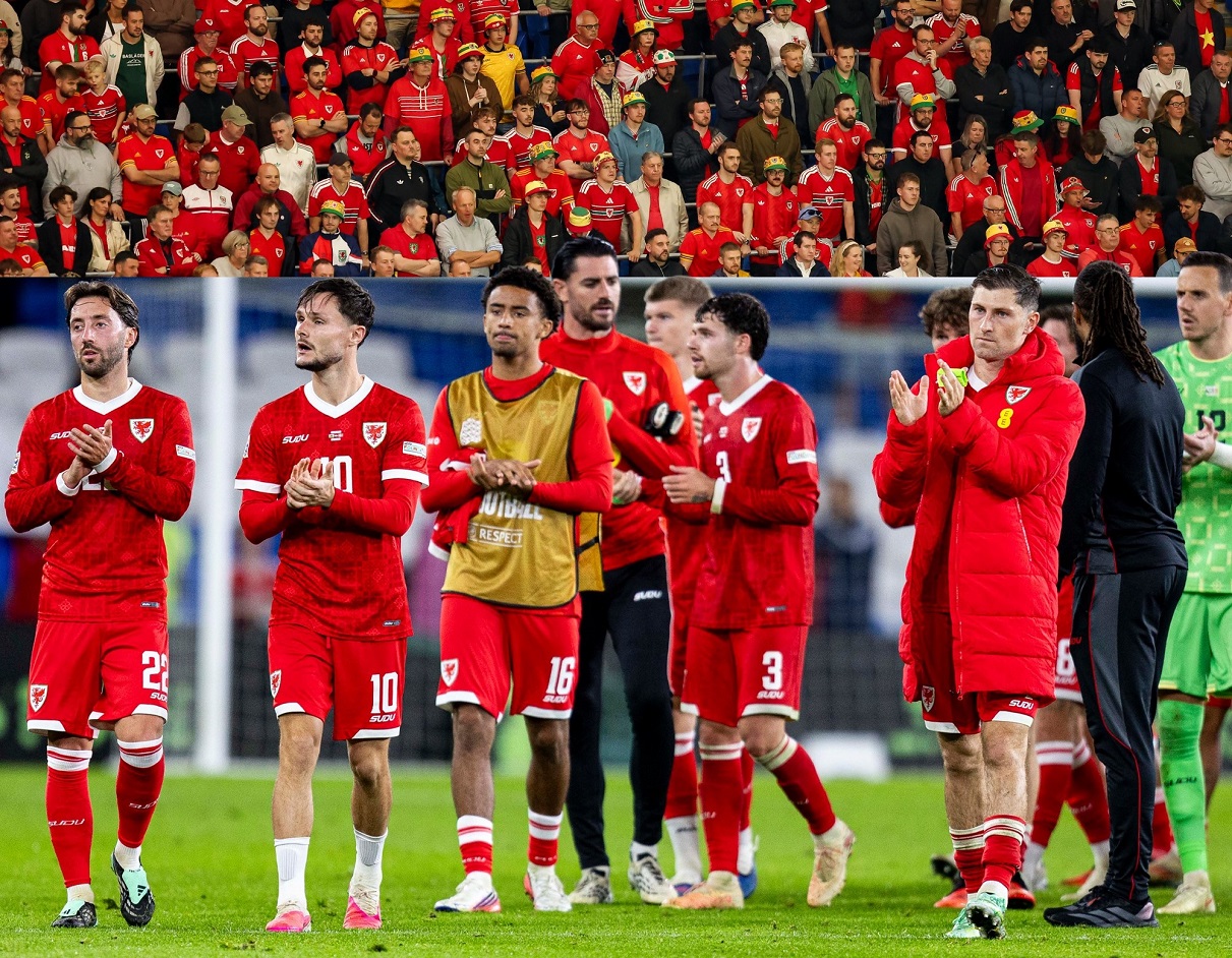 Wales players applauding fans after defeat by Denmark