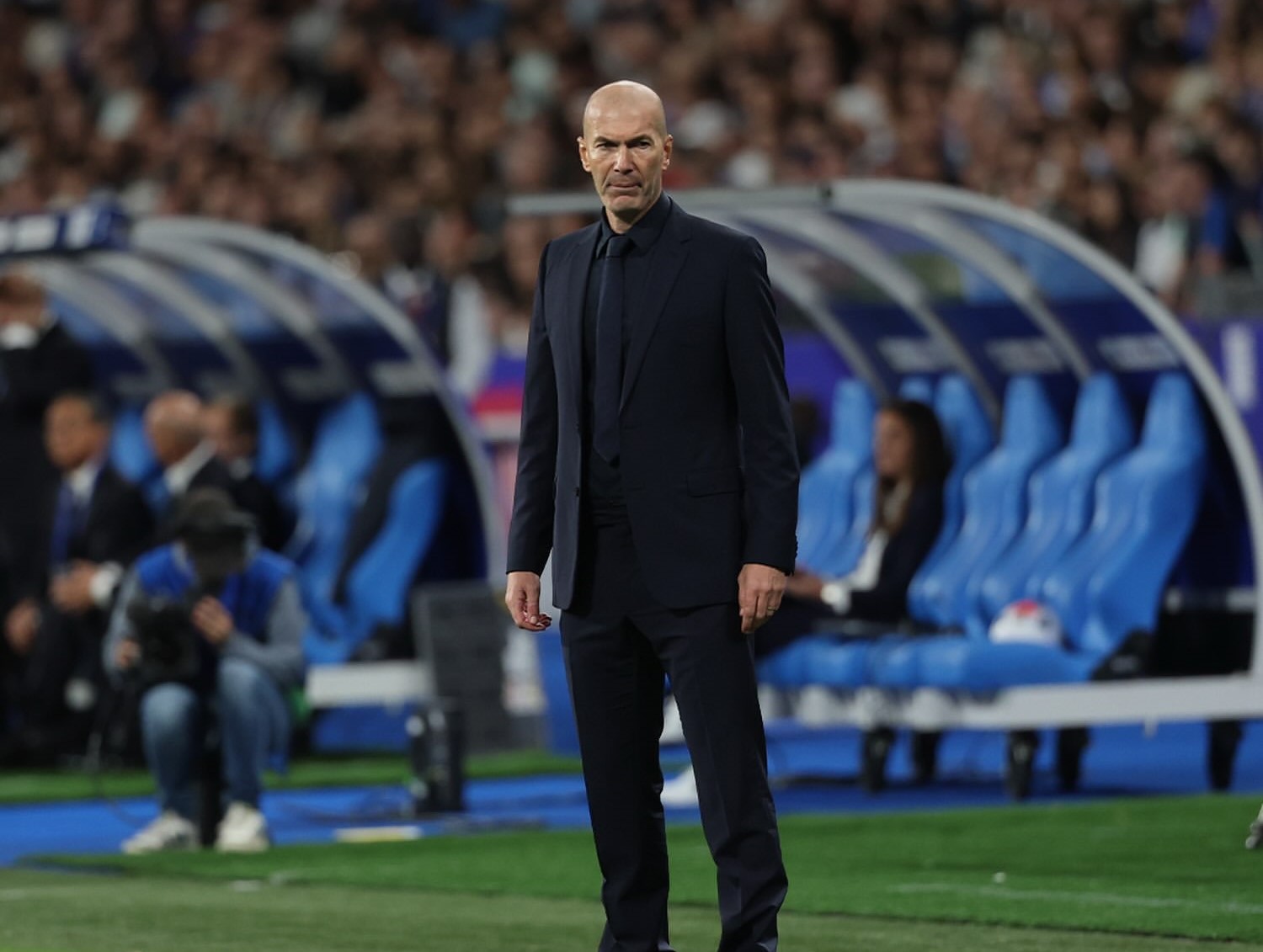 Zinedine Zidane standing on the sidelines during a France game